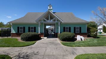 A two-story building with a gabled roof and a central entrance.
