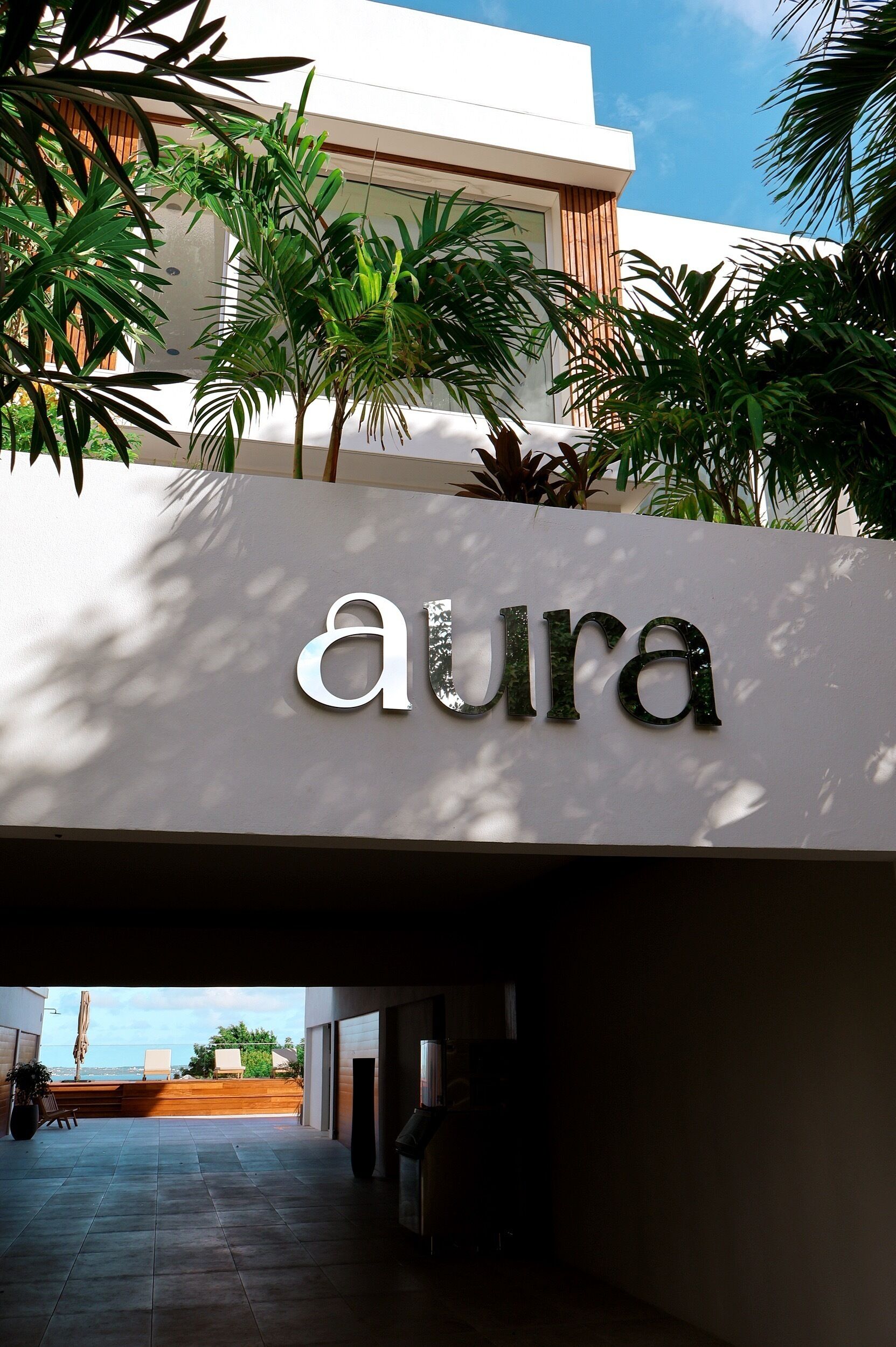 A building entrance with a sign reading "aura".