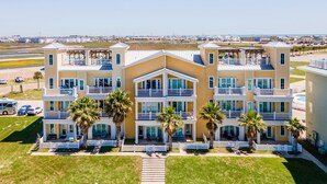 A multi-story hotel with balconies, a pool, and a view of the beach. - Marina Del Bell - Elevator! Boat Slip for Rent! (Port Aransas)