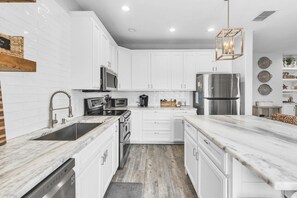 House, Multiple Beds, Patio, Pool View (Casa Azul) | Private kitchen | Coffee/tea maker, dining tables - Casa Azul - Boardwalk to the Beach! (Port Aransas)