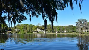 A calm lake with a wooden dock and trees with hanging moss. - Paradise Palms on Rainbow Ranch (Dunnellon)