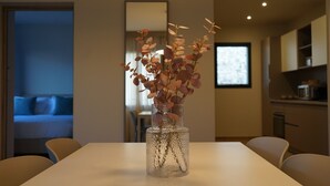 A modern kitchen with a microwave, oven, and cabinets. - Appartement 2 Chambres (Saint-Florent)