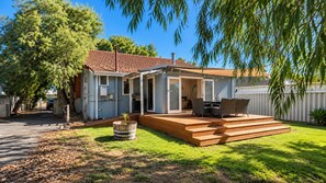A residential property with a covered patio, a barbecue area, and a fenced yard. - Barefoot Beach Cottage (Geographe)