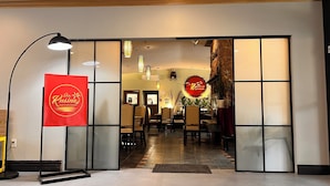 A restaurant entrance with a red sign, glass doors, and a tiled floor. - Park Inn - by Choice Hotels, Sydney (Sydney)