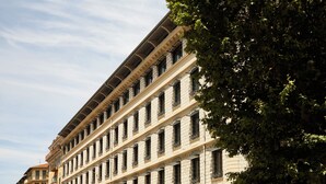 A multi-story building with a consistent architectural style, featuring numerous windows and balconies. - Mama Shelter Nice (Nice)