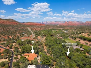 A residential area with houses, roads, and a creek.