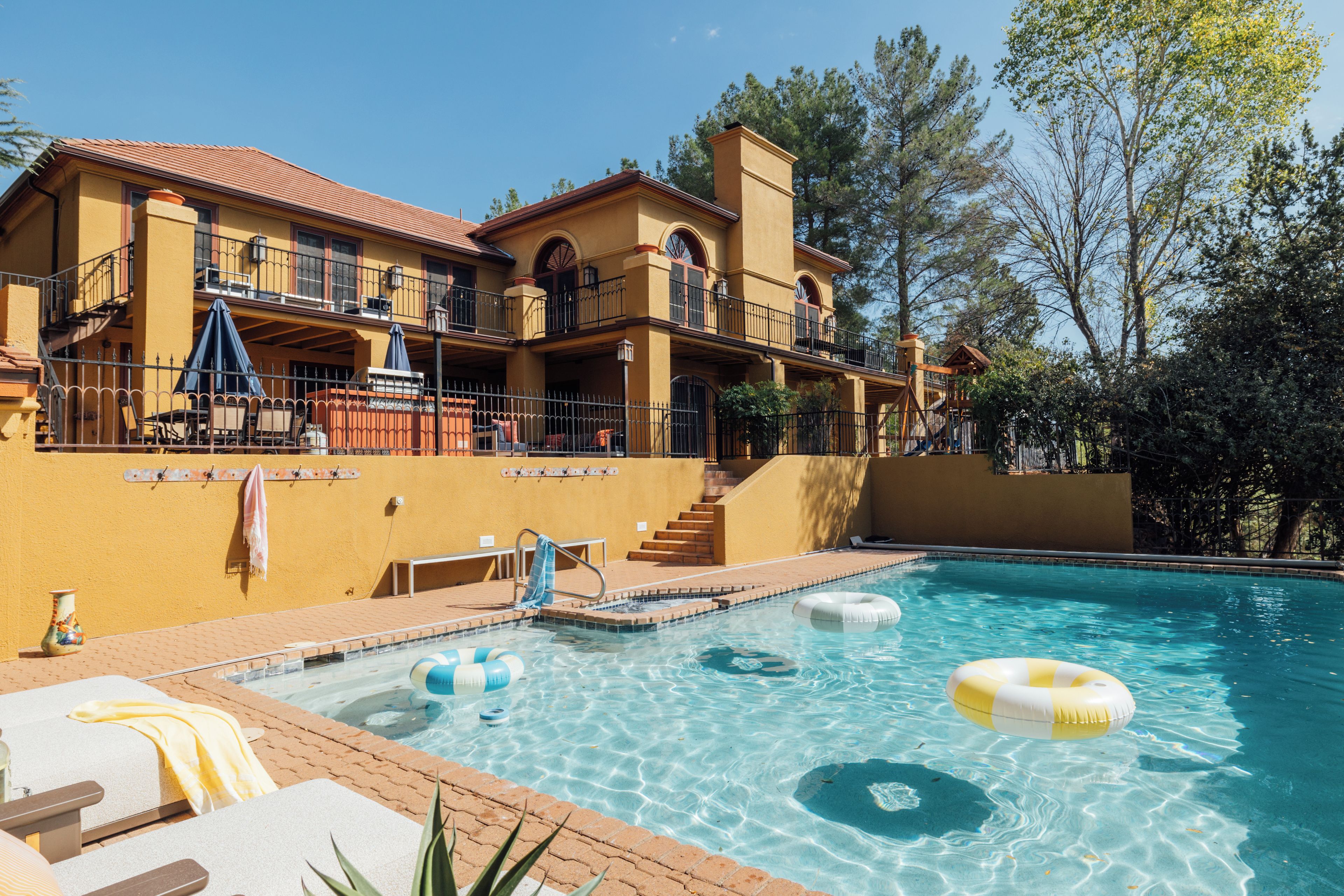 Private pool and terrace loungers beneath the main house. Open Mar 1-Nov 30.