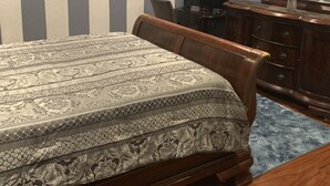 A bedroom with a bed, a dresser, a mirror, and a television. - Quiet Haven  (Freeport)