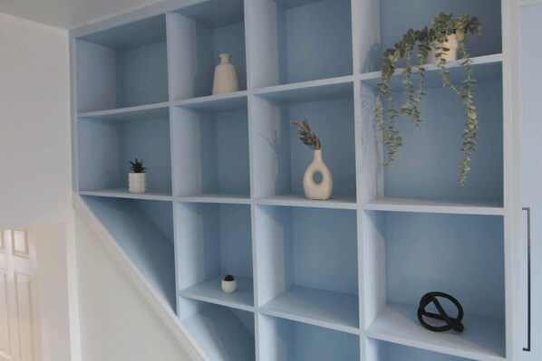 A blue shelving unit with various decorative items.