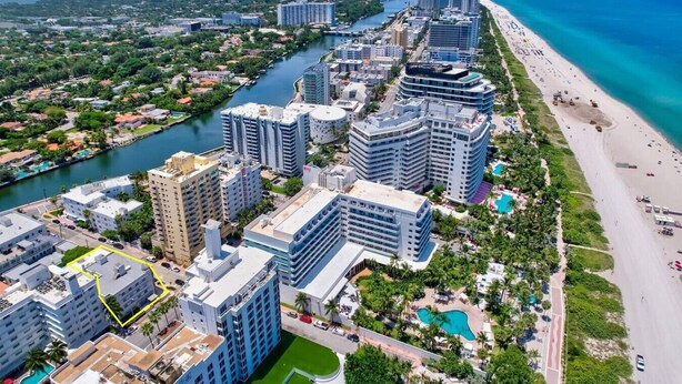 A coastal cityscape with high-rise buildings, a river, and a beach. - Newly remodeled apartment only 1 min to the beach! (Miami Beach)