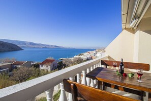 Enjoy a romantic dinner for two on this balcony overlooking the serene body of water.
