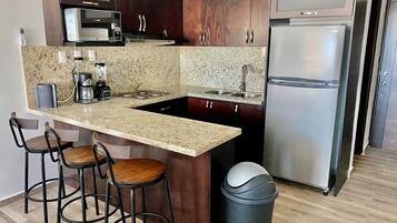 Fridge, microwave, stovetop, coffee/tea maker