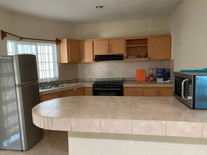 Fridge, microwave, stovetop, coffee/tea maker