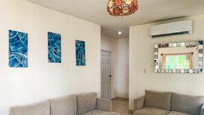 A living room with two sofas, a ceiling light fixture, and a wall-mounted air conditioner. - Altata, casa Las Aguilas (Altata)