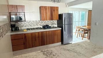 Fridge, microwave, stovetop, cookware/dishes/utensils