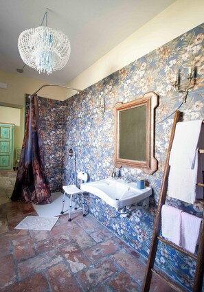A bathroom with a shower, a sink, a mirror, and a chandelier. - AGRITURISMO CASTELLO BECCARIA (Pieve del Cairo)