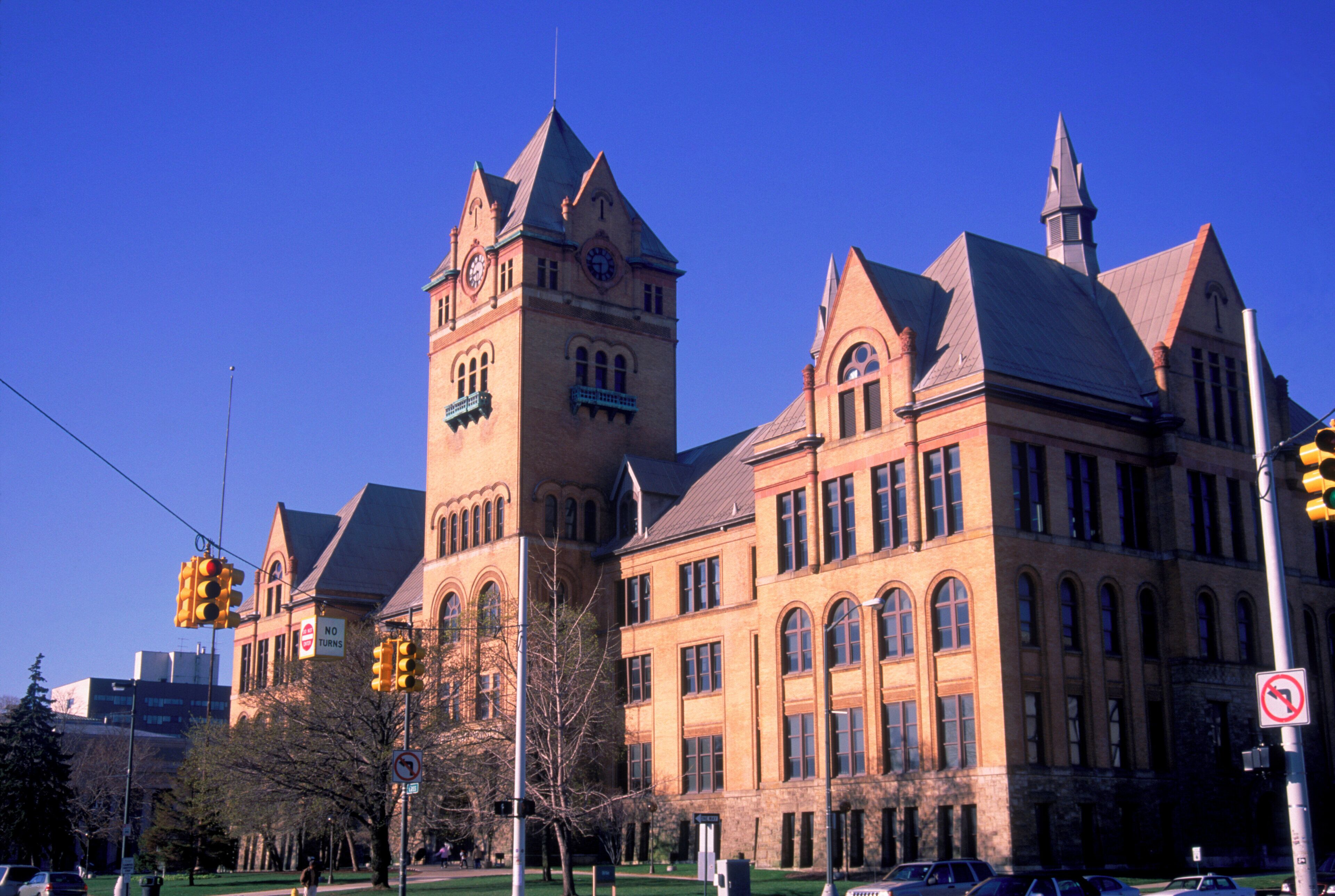 A large, historic building with a prominent tower and arched windows.