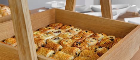 A wooden box filled with assorted pastries.