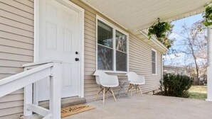 A house with a white door, a covered porch, and two white chairs. - Cool Ranch (Murfreesboro)