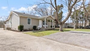 A single-story house with a front porch, a small front yard, and a driveway. - Cool Ranch (Murfreesboro)