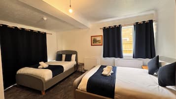Deluxe Quadruple Room, Garden View | 1 bedroom, individually furnished, laptop workspace, soundproofing