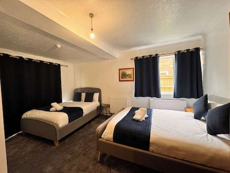 Deluxe Quadruple Room, Garden View | Individually furnished, laptop workspace, soundproofing, free WiFi