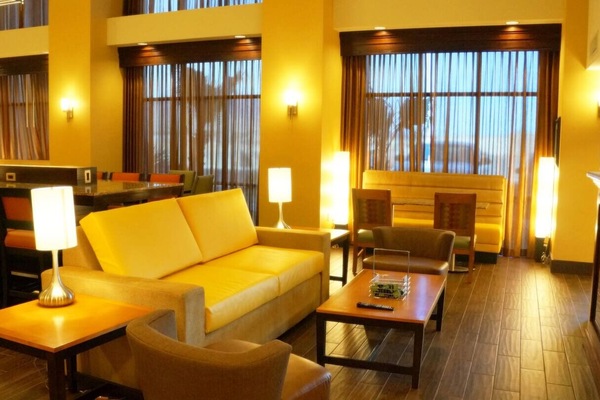 Unwind on plush seating with warm lighting and calm vibes.