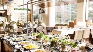 A buffet setup with various food items and a glass display case. - Sono Calm Vivaldi Park (Hongcheon)