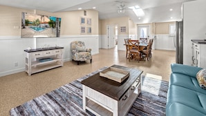 A spacious living area with a pool view, a dining table, and a cozy seating area. - Key Life Reef l Semi-Private Pool, Walk to the Beach! (Siesta Key)