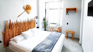 A modern bedroom with a large bed, a ceiling fan, and a window with curtains. - Corazon de Teco (Tecolutla)