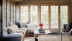 A cozy room with a sofa, a table, and a fireplace. - Serene Estate: Heated Pool, Tennis, Sauna, Hot Tub (Catskill)