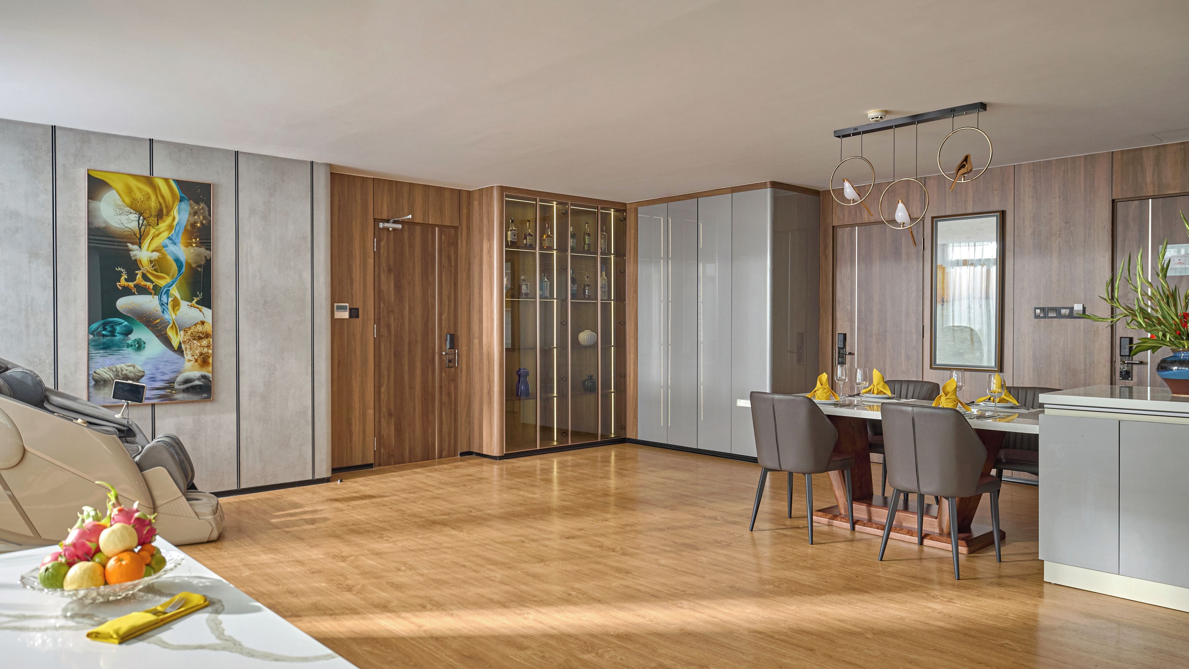 A modern dining area with a wooden floor, a glass partition, and a dining table set for four.
