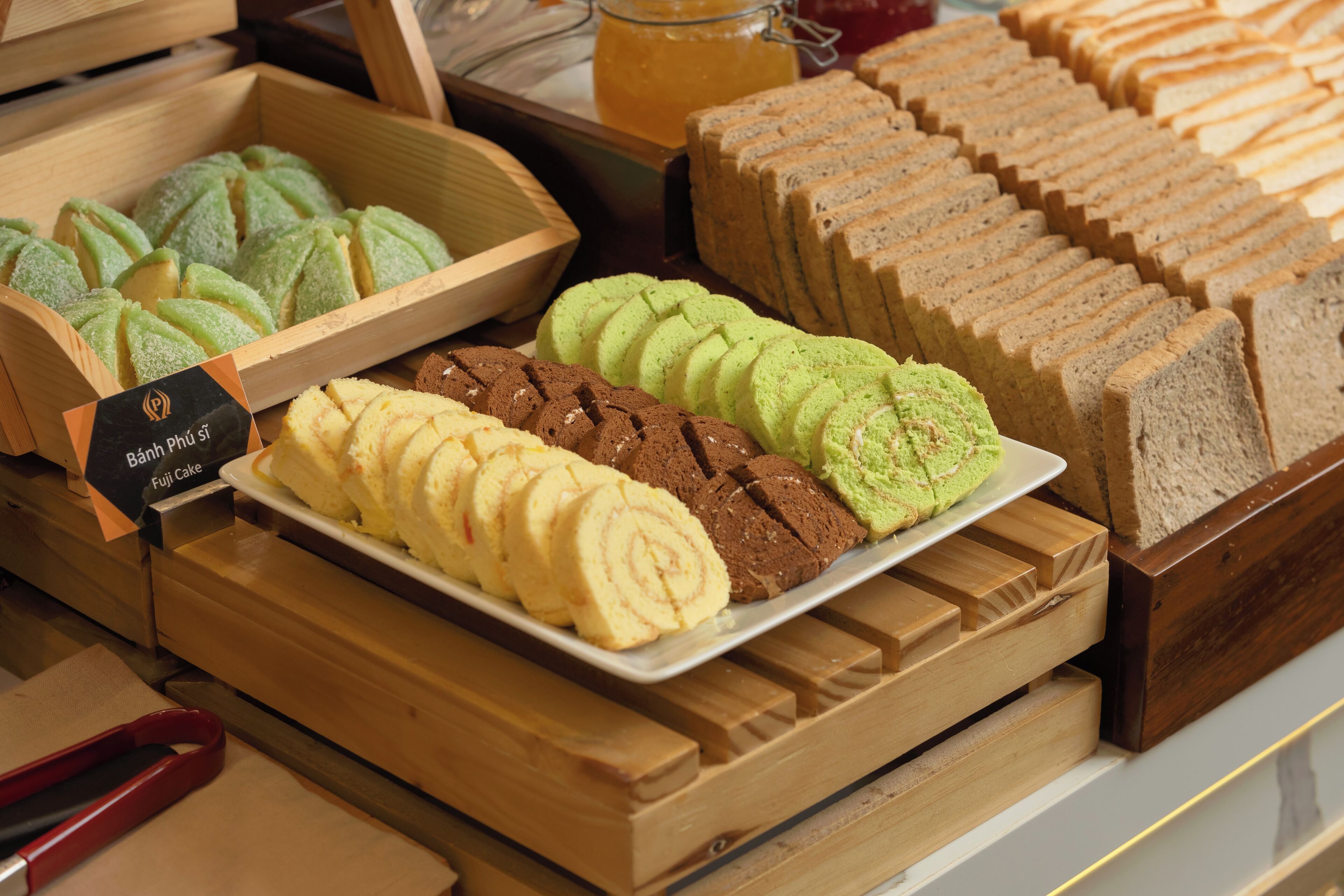 Une vitrine présentant une variété de pâtisseries et de pains dans une boulangerie.