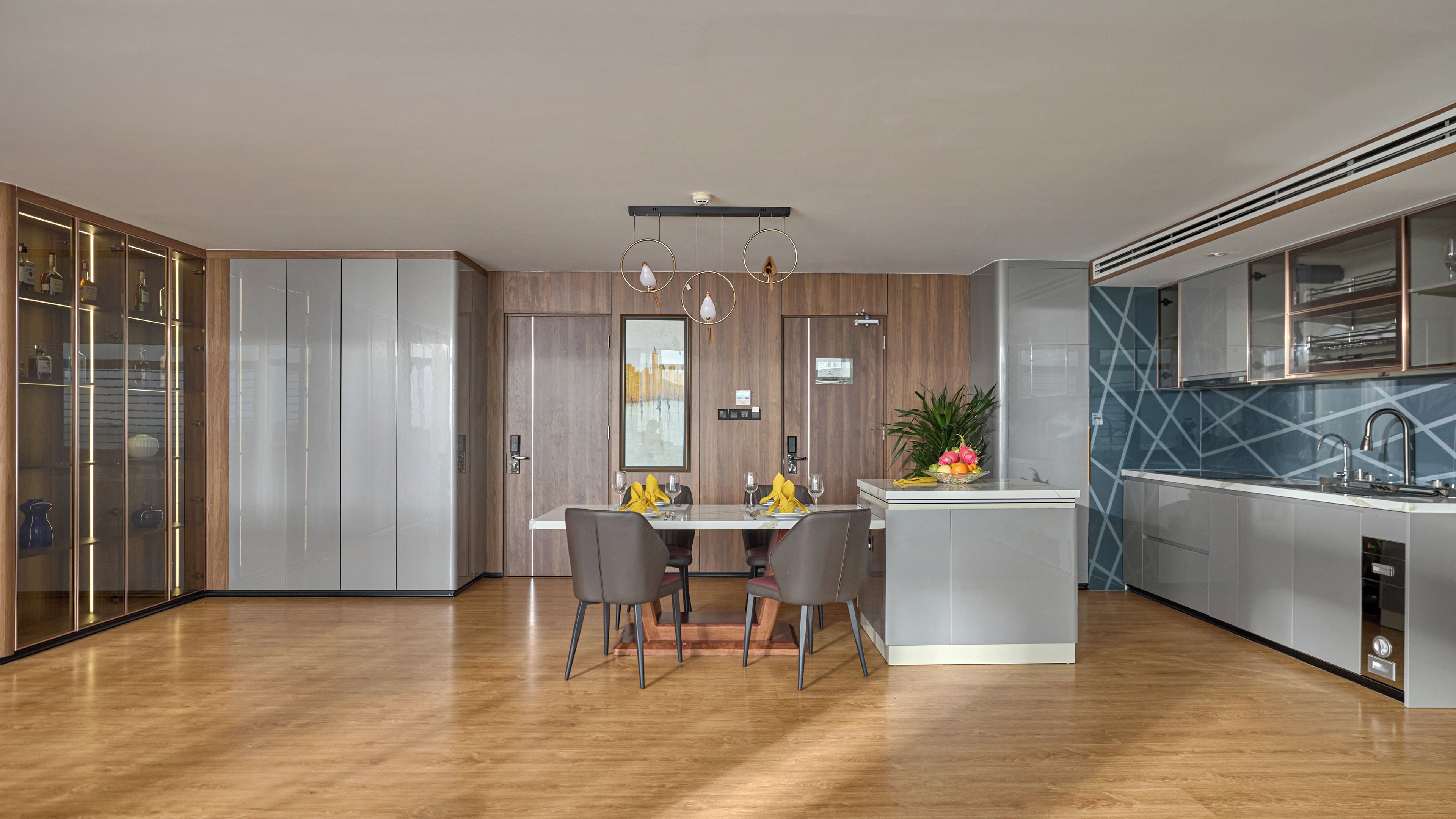 A modern kitchen with a central island, wooden cabinets, and a built-in dishwasher.