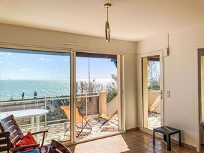 Enjoy the expansive view from the outdoor space with a round table and comfortable seating.
