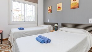 A hotel room with two beds, a window with a view, and three paintings on the wall. - Stunning private villa for 6 guests with private pool, A/C, WIFI, TV and terrace (Miami Platja)