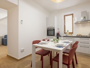A modern kitchen with white cabinets, a built-in oven, and a window above the sink. - Beautiful apartment for 6 people with A/C, WIFI and TV (Balestrate-foce)