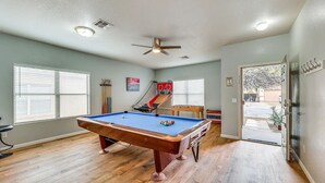 A pool table in a room with a ceiling fan, a futsal court, and a door leading outside. - Mesa Vacation Home - Sleeps 12 - Close to Golf Courses and SO MUCH MORE! (Mesa)