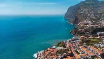 A coastal town with terraced houses, a prominent church, and a clear view of the sea.