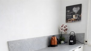 A kitchen with a Bosch refrigerator, a coffee maker, and a kettle on the counter. - Apartment 'Dream Home' with Balcony and Wi-Fi (Friedrichshafen)