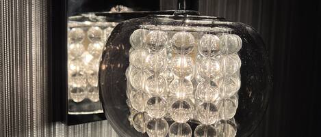 A wall-mounted light fixture with multiple clear glass bulbs.