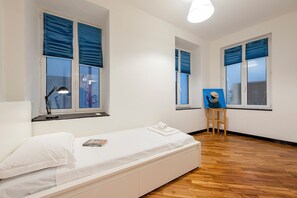 Un dormitorio con una cama individual, un escritorio con una silla y un cuadro en la pared.