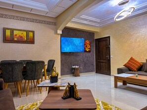 Deluxe Apartment | Living area | 55-inch Smart TV with digital channels, Netflix, streaming services