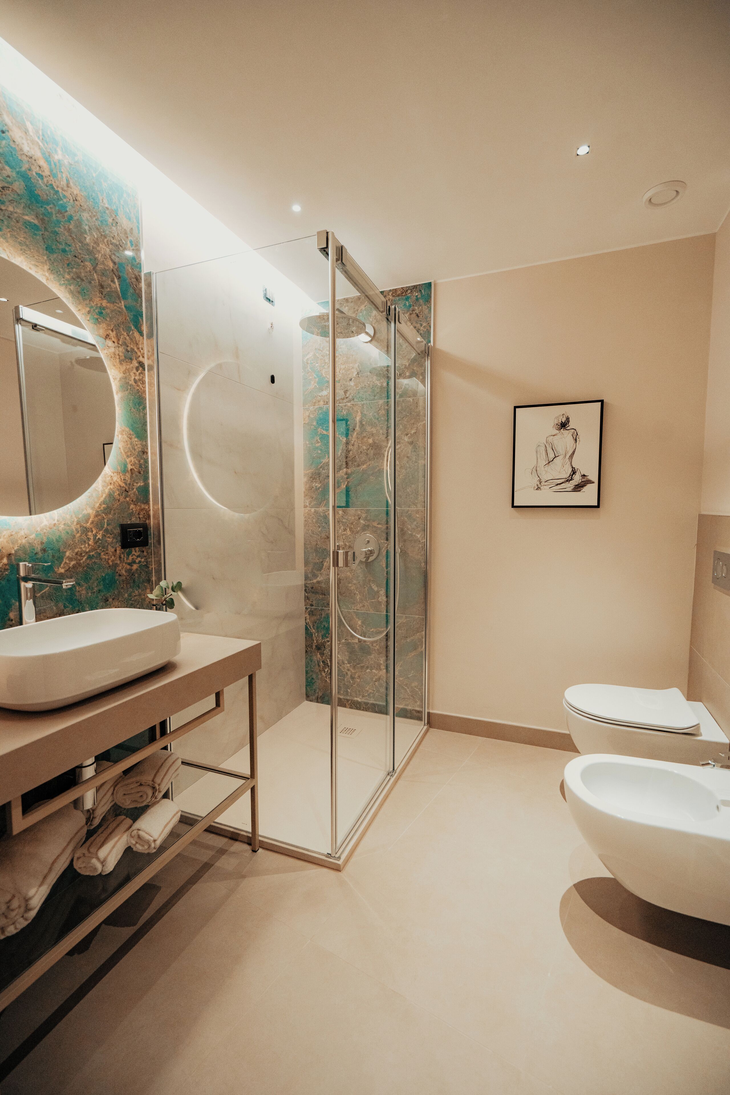 A modern bathroom with a glass-enclosed shower, a large mirror, and two sinks.