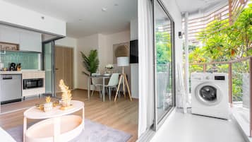 Business Apartment, Balcony, Pool View | Living area