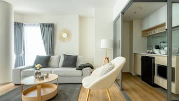 Business Apartment, Balcony, Pool View | Living area