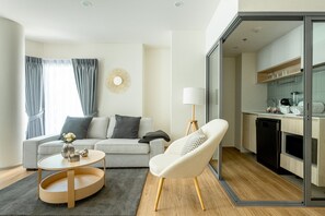 Business Apartment, Balcony, Pool View | Living area