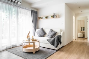 Business Apartment, Balcony, Pool View | Living area | 55-inch Smart TV with digital channels