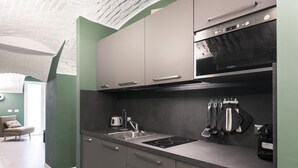 A modern kitchen with grey cabinets, a built-in oven, and a stainless steel sink. - Easylife - Elegance in the Isola district (Milano)