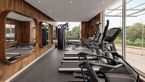 A gym with treadmills, weight machines, and dumbbells.